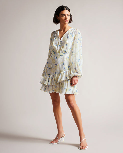 SUZIIEE-Dresses-Make every day a fashion show in SUZIIEE. Featuring our gorgeous poppy print and all the ruffles your heart desires, this versatile mini dress will take you from coffee mornings to dinner dates with ease.The fabric of this product is made with 30% recycled polyester. Using recycled polyester helps divert plastic waste from ending in landfills, and helps us to reduce our dependence on virgin materials. Mini dress Daisy print Long blouson sleeves Asymmetric ruffled hem Self tie neckline Zip fa